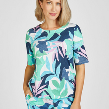 Load image into Gallery viewer, female model wearing rabe floral tshirt with hand in pocket looking at camera

