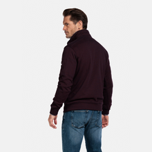 Load image into Gallery viewer, Man wearing a dark jacket and blue jeans on a white background

