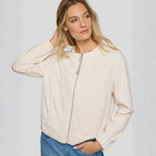 Load image into Gallery viewer, Woman wearing a beige jacket with a zipper on a plain background
