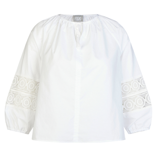 White blouse with intricate lace detailing on sleeves against a white background