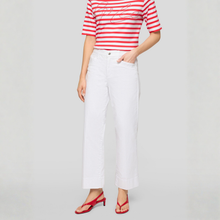 Load image into Gallery viewer, Person wearing a red and white striped shirt with white pants on a gray background
