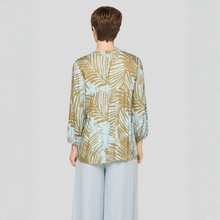 Load image into Gallery viewer, Person wearing a patterned blouse with a plain background
