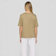 Load image into Gallery viewer, Person wearing a beige t-shirt and white pants on a plain background
