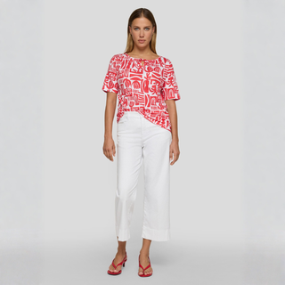 Red white print top on lady with white cut offs 