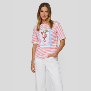 Woman wearing a red and white striped t-shirt with a graphic design on a plain background