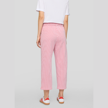 Load image into Gallery viewer, Person wearing pink checkered pants and a white shirt on a gray background

