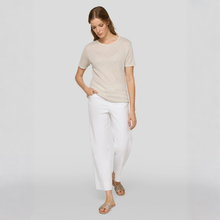 Load image into Gallery viewer, Woman wearing a beige top and white pants on a plain background
