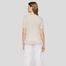 Load image into Gallery viewer, Woman wearing a beige top and white pants on a light gray background
