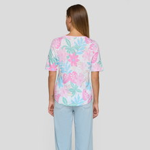 Load image into Gallery viewer, Woman wearing a pastel floral top and light blue jeans on a white background
