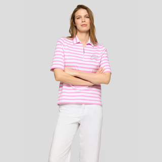 Woman wearing a pink and white striped polo shirt against a gray background