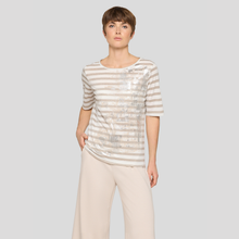 Load image into Gallery viewer, Woman wearing a striped shirt and beige pants on a plain background
