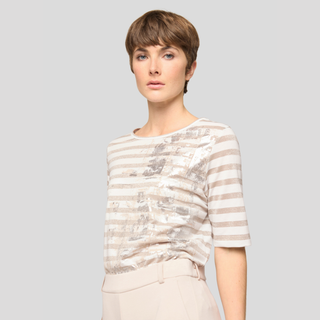 Woman wearing a striped shirt against a plain background