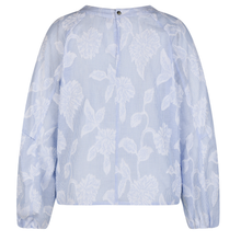 Load image into Gallery viewer, Light blue blouse with floral pattern on a white background
