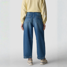 Load image into Gallery viewer, Person wearing blue jeans and a yellow sweater on a white background
