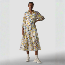 Load image into Gallery viewer, Woman wearing a floral dress on a plain background
