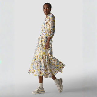 Woman wearing a floral dress with a plain background