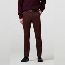 Load image into Gallery viewer, A person wearing slim-fit burgundy trousers with a black belt, a dark burgundy sweater, and black leather shoes, shown from the chest down against a light gray studio background.

