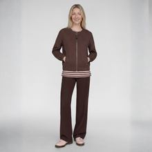 Load image into Gallery viewer, A woman modeling a brown zip-up jacket and matching wide-leg pants set, featuring a striped hem detail, against a light gray studio background.

