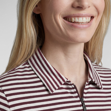 Load image into Gallery viewer, Close-up of a woman wearing a collared zip-front top with narrow burgundy and off-white horizontal stripes against a light gray background.
