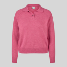 Load image into Gallery viewer, A pink knit polo sweater with raglan sleeves, a collar, and a two-button placket, shown on a solid light gray background.
