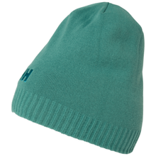Load image into Gallery viewer, A teal green knit beanie hat with a ribbed cuff and a small embroidered dark green Helly Hansen logo on the side, shown against a plain white background.
