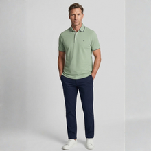 Load image into Gallery viewer, Man wearing a green polo shirt and navy pants on a light gray background

