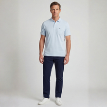 Load image into Gallery viewer, Man wearing a light blue polo shirt and navy pants on a plain background
