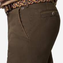 Load image into Gallery viewer, Close-up of dark brown chinos or trousers showing the back pocket, button closure, belt loop, and waistband with a woven multicolor belt.
