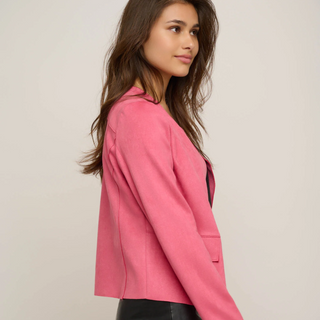 female model wearing pink slim fit jacket looking away from camera