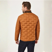 Load image into Gallery viewer, A man wearing a brown quilted jacket, viewed from the back, standing against a plain off-white background.
