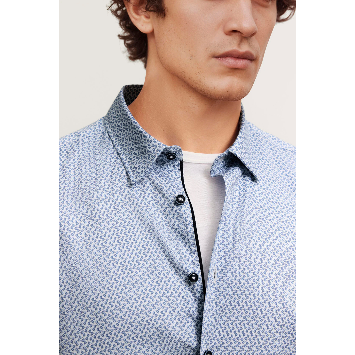 Load image into Gallery viewer, Close-up of a person wearing a patterned shirt with a plain background
