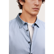 Load image into Gallery viewer, Close-up of a person wearing a patterned shirt with a plain background
