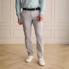 Load image into Gallery viewer, Person wearing light gray pants, a light blue shirt, and white sneakers in a room with wooden flooring and paneled walls.
