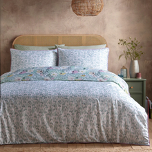 Load image into Gallery viewer, Bedroom with floral bedding and a wooden headboard
