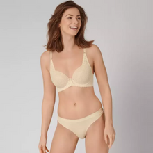Load image into Gallery viewer, A picture of a model wearing the Aura Spotlight Bra and Thong in Creamy Dream. 
