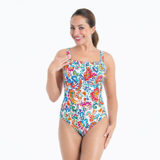 Woman wearing a colorful floral swimsuit on a white background