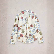 Load image into Gallery viewer, Floral patterned shirt on a light gray background
