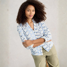 Load image into Gallery viewer, Woman wearing a patterned shirt with rolled-up sleeves against a neutral background
