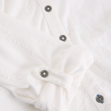 Load image into Gallery viewer, Close-up of a white textured fabric with buttons on a white background

