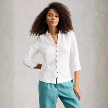 Load image into Gallery viewer, Woman wearing a white shirt and teal pants against a gray background
