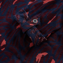 Load image into Gallery viewer, Close-up of a shirt with a red and blue pattern and button detail.
