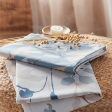 Load image into Gallery viewer, Folded fabric with floral pattern on a woven surface
