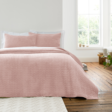 Load image into Gallery viewer, Pink quilted bedspread on a bed in a bright room with a window and wooden floor.
