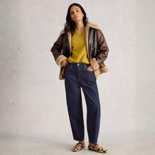 Load image into Gallery viewer, Woman wearing a brown leather jacket with fur trim, yellow sweater, and blue jeans against a plain background
