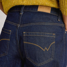 Load image into Gallery viewer, Close-up of blue jeans with a brand label on a white background
