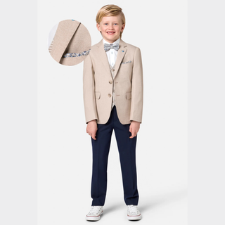 Young boy in a formal outfit with a beige blazer, navy pants, and white shoes, holding a hat.