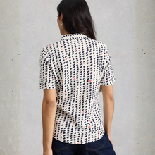 Load image into Gallery viewer, Back view of Model posing wearing White Stuff Ann SS Jersey Shirt, with a light grey background.
