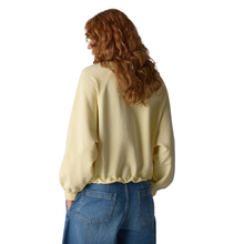 Load image into Gallery viewer, Person wearing a beige sweatshirt and blue jeans on a white background
