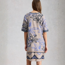Load image into Gallery viewer, Woman wearing a patterned dress with a neutral background
