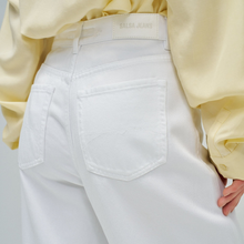 Load image into Gallery viewer, White jeans with 'Salsa Jeans' label worn by a person in a yellow shirt.
